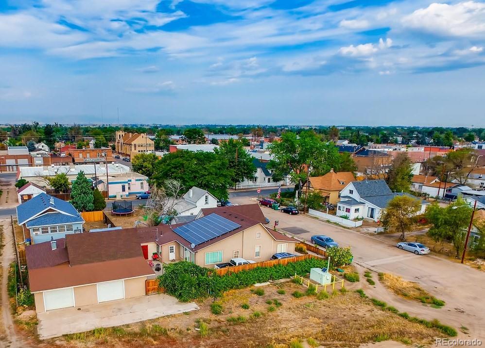 816 3rd Street Fort Lupton, CO 80621 - Photo 5 of 31 an aerial view of a house with a garden and lake view