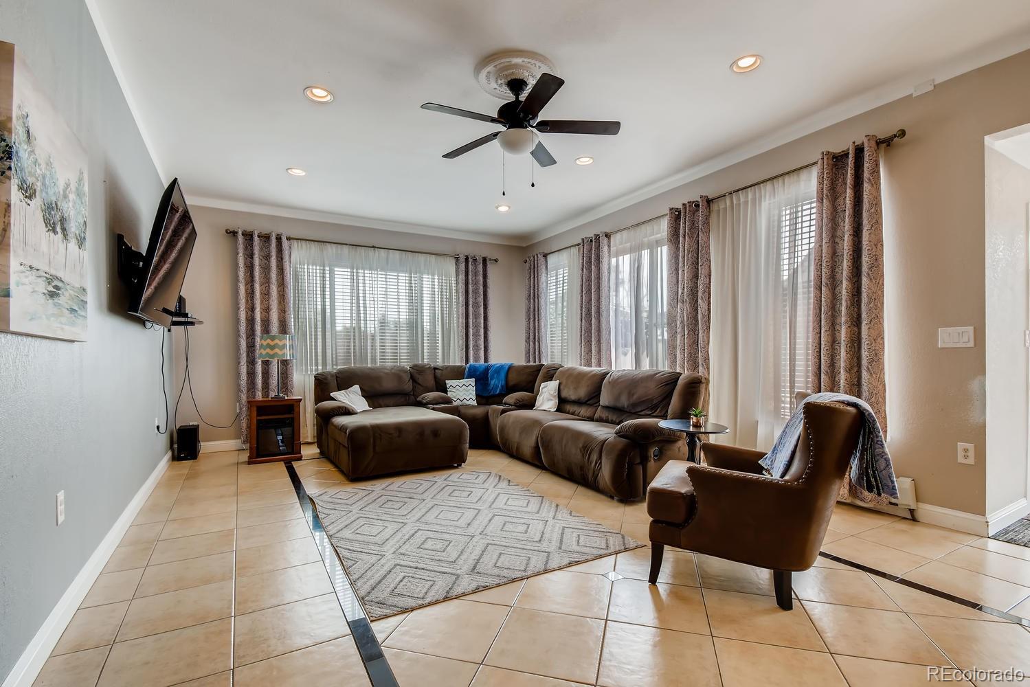 816 3rd Street Fort Lupton, CO 80621 - Photo 7 of 31 a living room with furniture and a window