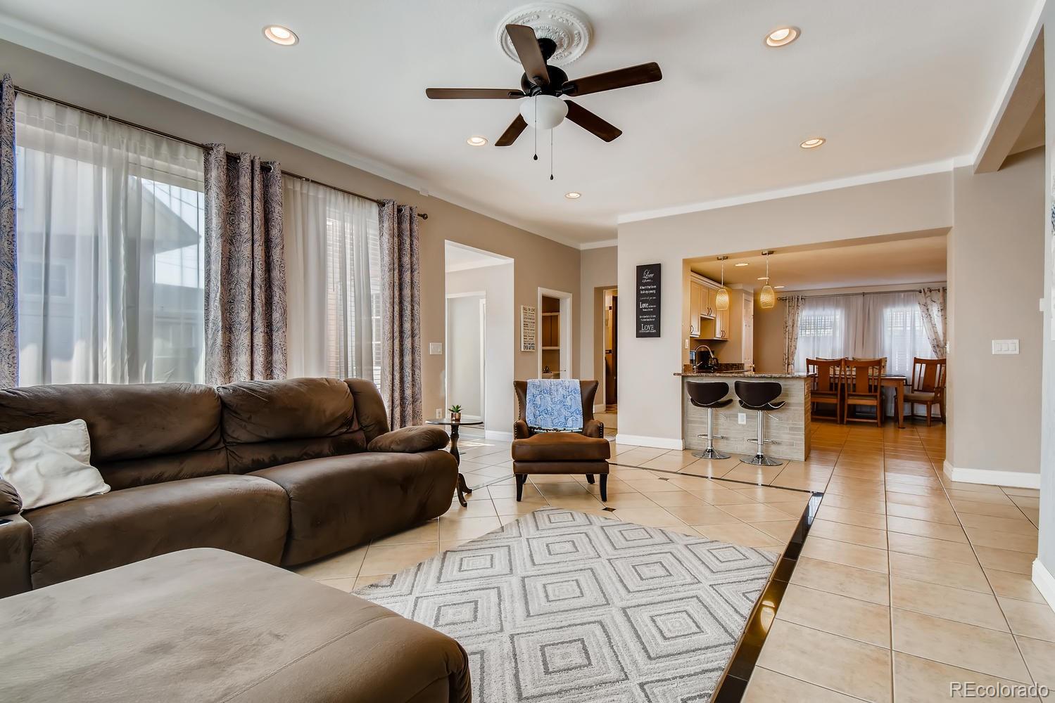 816 3rd Street Fort Lupton, CO 80621 - Photo 8 of 31 a living room with furniture and a large window