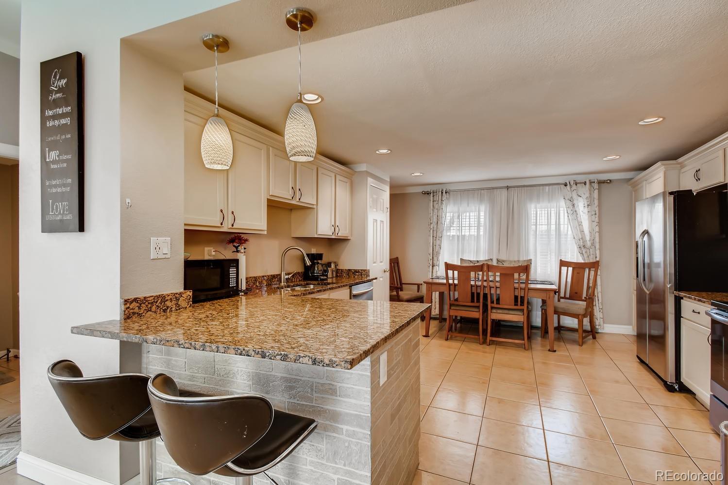 816 3rd Street Fort Lupton, CO 80621 - Photo 9 of 31 a kitchen with kitchen island granite countertop lots of counter top space