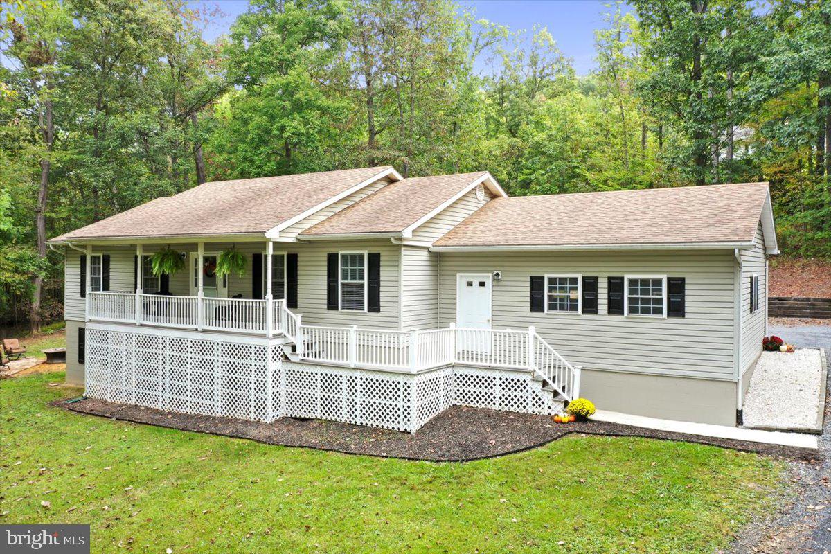 a view of a house with a yard and sitting area