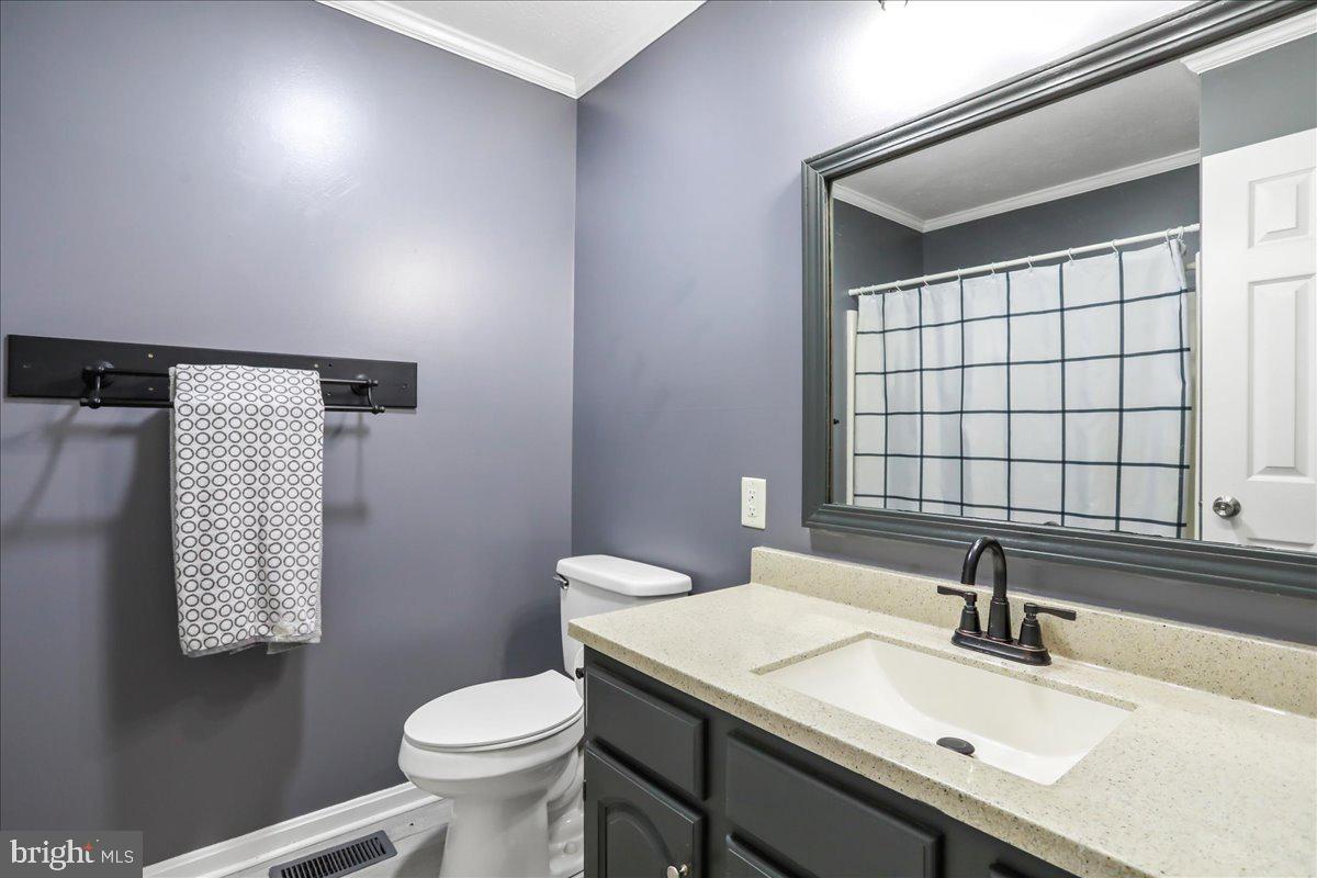 2726 Cave Ridge Road Mount Jackson, VA 22842 - Photo 16 of 39 a bathroom with a sink toilet and mirror