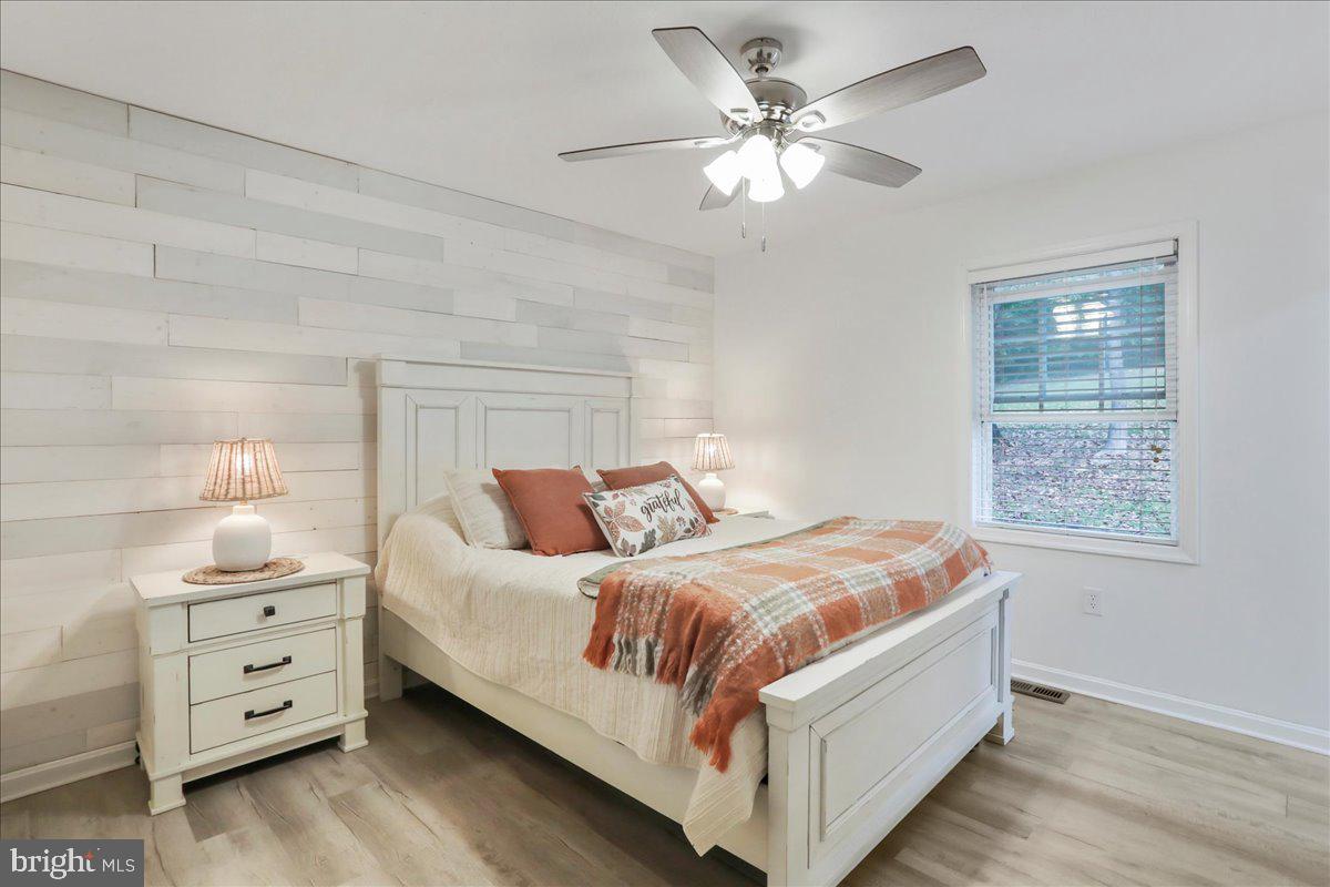 2726 Cave Ridge Road Mount Jackson, VA 22842 - Photo 20 of 39 a bedroom with a large bed and a chandelier