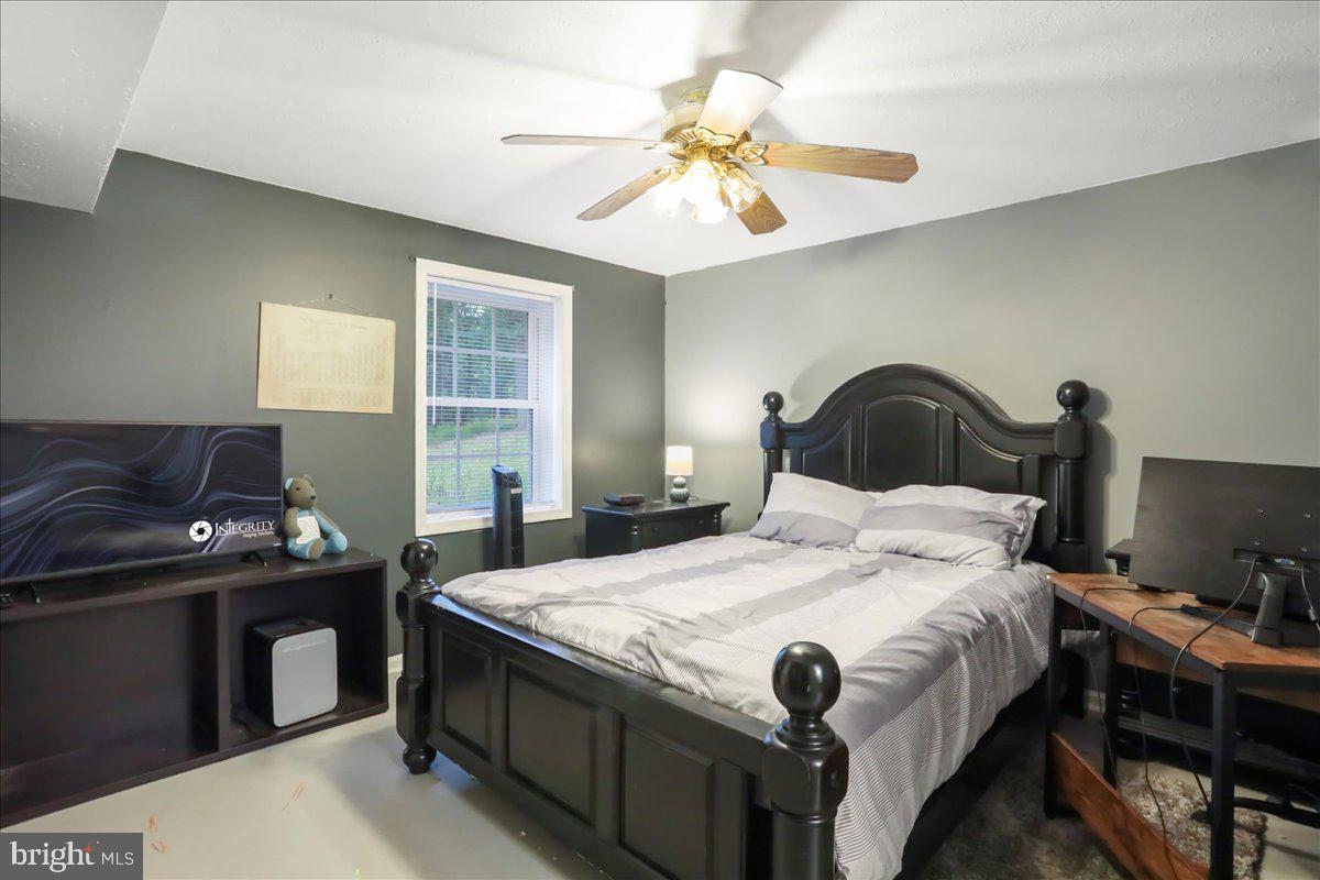 2726 Cave Ridge Road Mount Jackson, VA 22842 - Photo 25 of 39 a bedroom with a bed and a chandelier