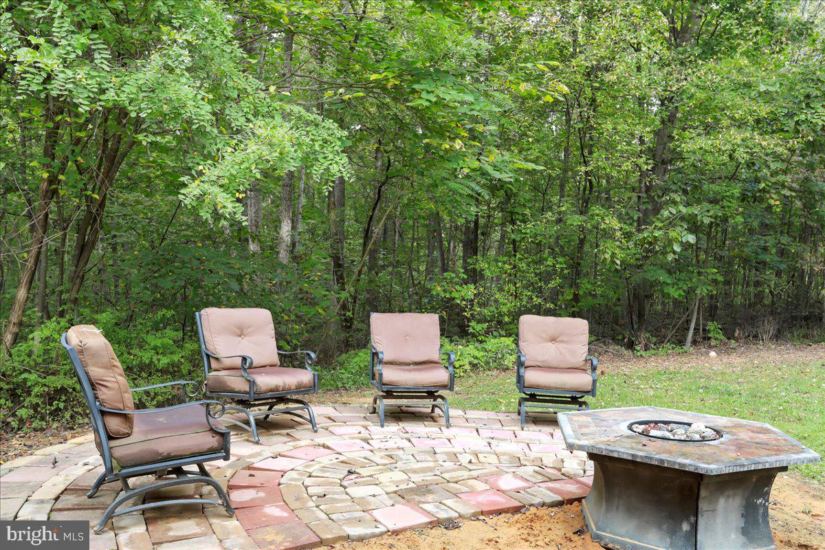 2726 Cave Ridge Road Mount Jackson, VA 22842 - Photo 32 of 39 a backyard of a house with table and chairs