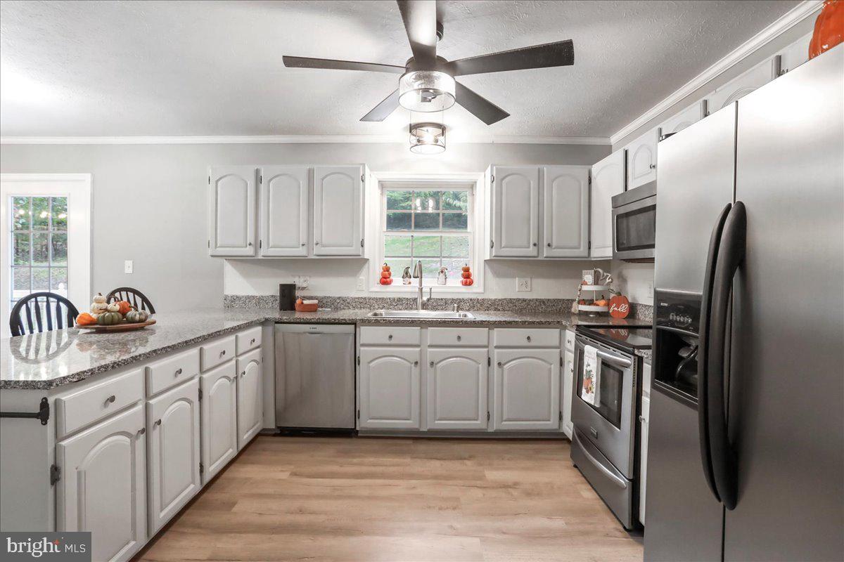2726 Cave Ridge Road Mount Jackson, VA 22842 - Photo 6 of 39 a kitchen with granite countertop a sink stainless steel appliances and window