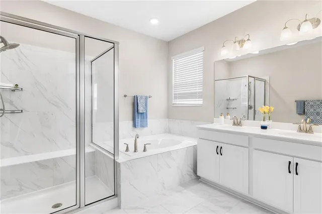 a bathroom with a tub sink and mirror