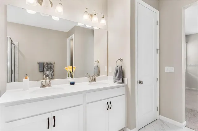 a bathroom with a double vanity sink and a mirror