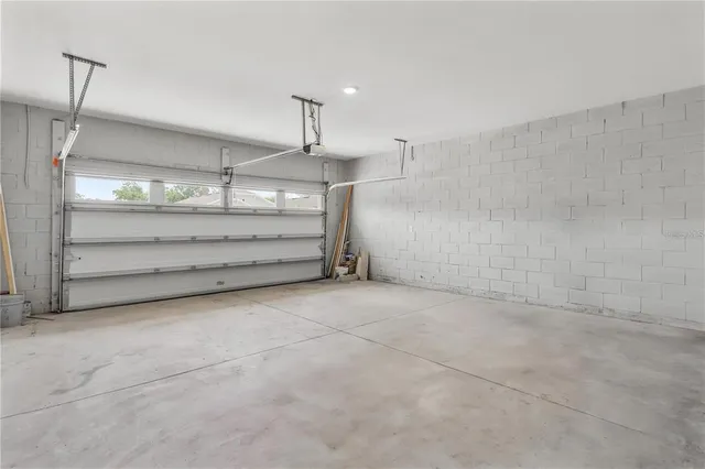 a room with natural light and kitchen view