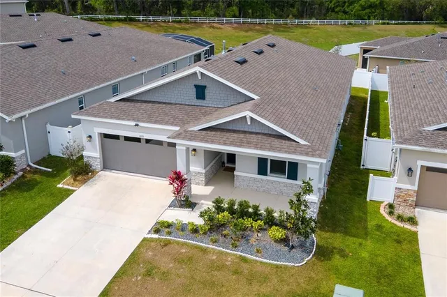 an aerial view of a house with swimming pool garden and outdoor seating