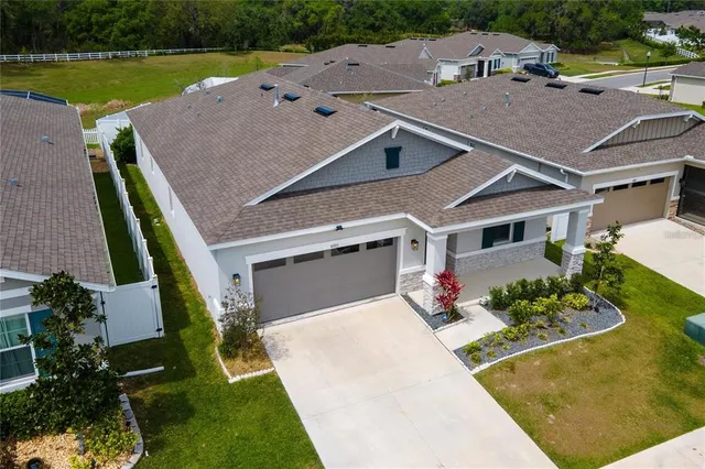 an aerial view of a house with a yard basket ball court and outdoor seating