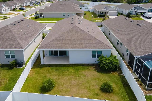 an aerial view of multiple houses with yard