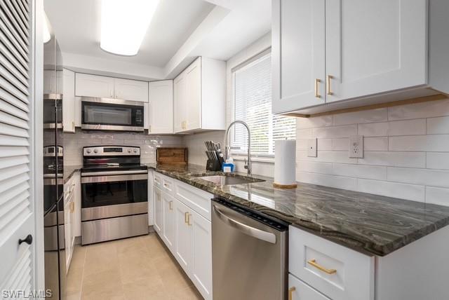 1251 7th Avenue North, Unit 307 Naples, FL 34102 - Photo 13 of 23 a kitchen with granite countertop a sink and steel appliances