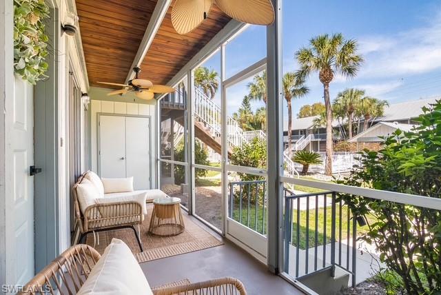 1251 7th Avenue North, Unit 307 Naples, FL 34102 - Photo 14 of 23 a balcony with table and chairs
