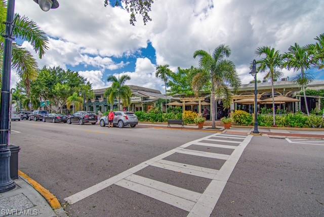 1251 7th Avenue North, Unit 307 Naples, FL 34102 - Photo 21 of 23 a group of cars parked in front of a building