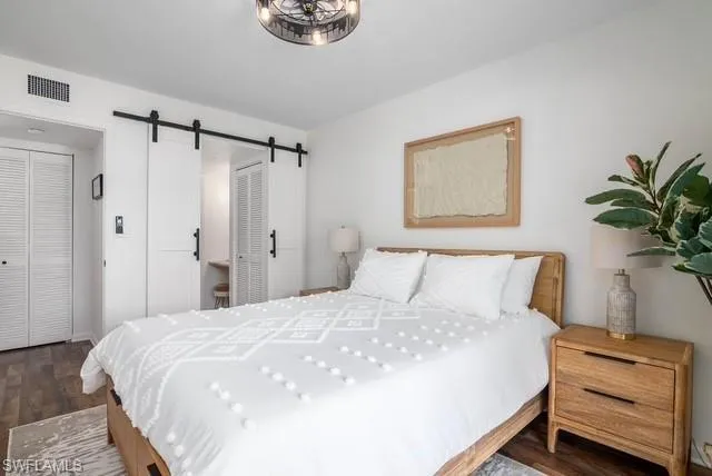 a bedroom with a bed and a potted plant