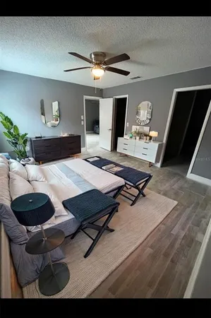 a living room with furniture and wooden floor