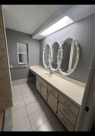 a bathroom with a double vanity sink and mirror