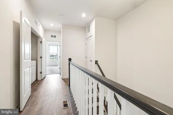a view of a hallway with wooden floor