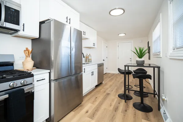 a kitchen with stainless steel appliances a refrigerator and a stove top oven