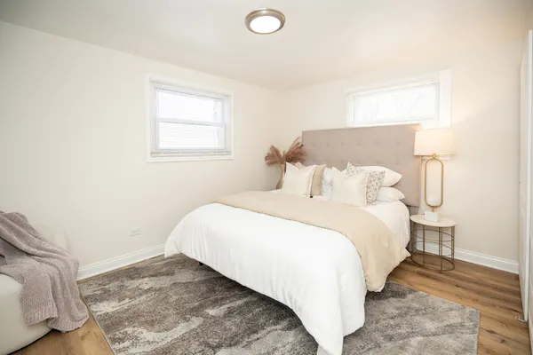 a bedroom with a bed and a night stand