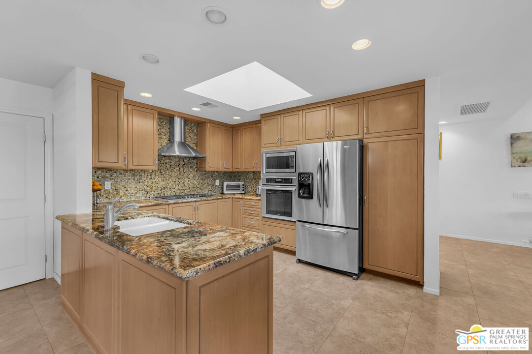 10 Colgate Drive Rancho Mirage, CA 92270 - Photo 17 of 45 a kitchen with a refrigerator a microwave and sink