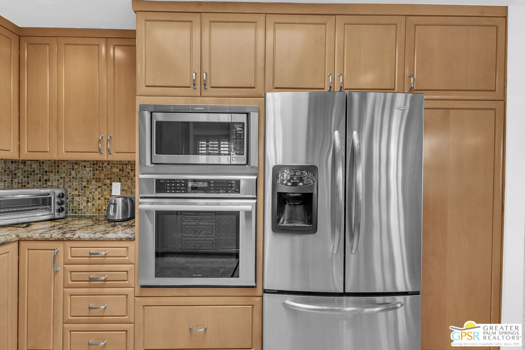 10 Colgate Drive Rancho Mirage, CA 92270 - Photo 19 of 45 a kitchen with cabinets and stainless steel appliances