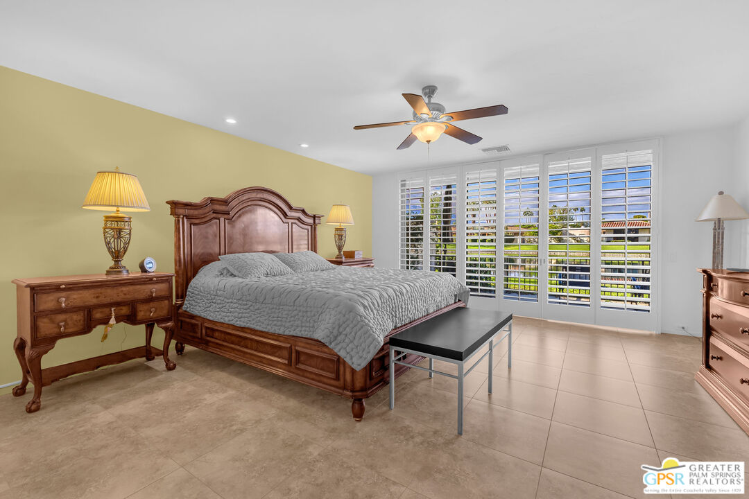 10 Colgate Drive Rancho Mirage, CA 92270 - Photo 25 of 45 a bedroom with a bed and a chandelier