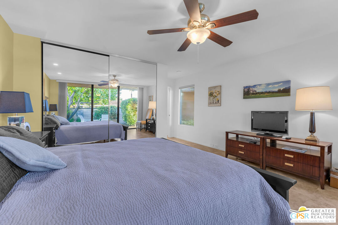 10 Colgate Drive Rancho Mirage, CA 92270 - Photo 34 of 45 a bedroom with a bed flat screen tv and a large window
