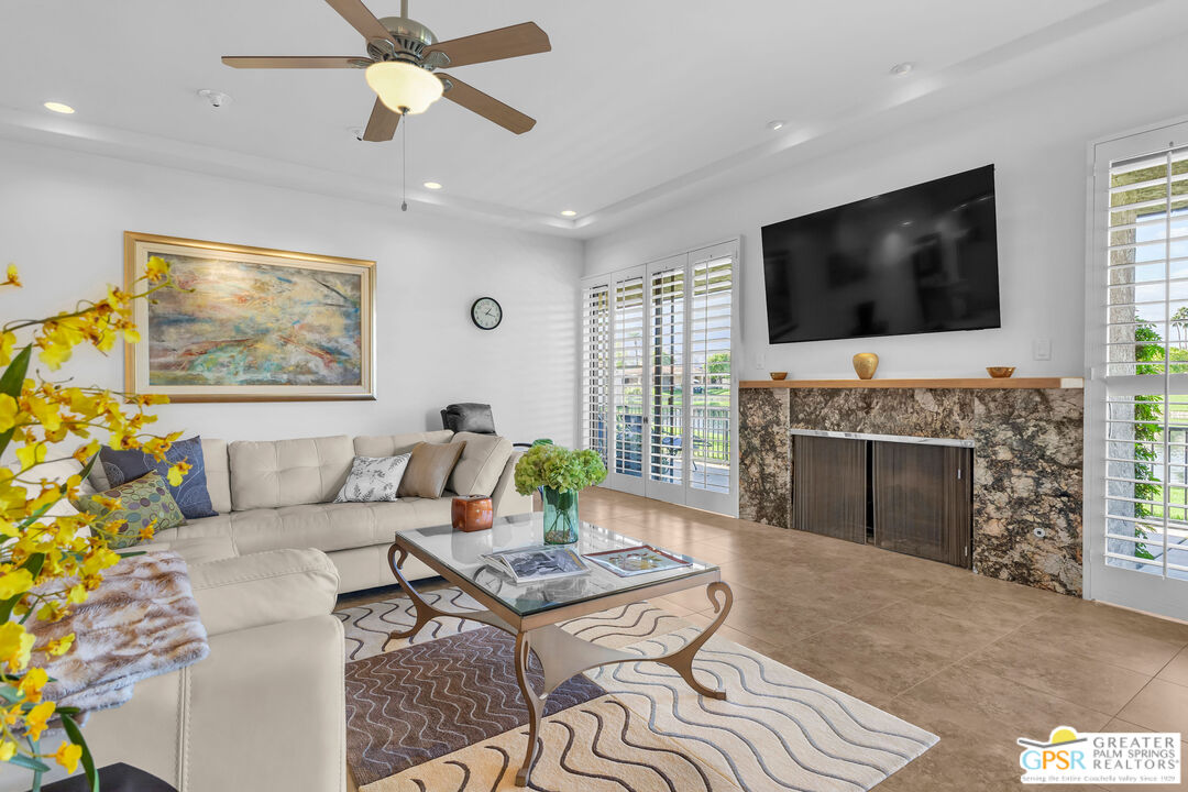 10 Colgate Drive Rancho Mirage, CA 92270 - Photo 8 of 45 a living room with furniture a flat screen tv and a fireplace