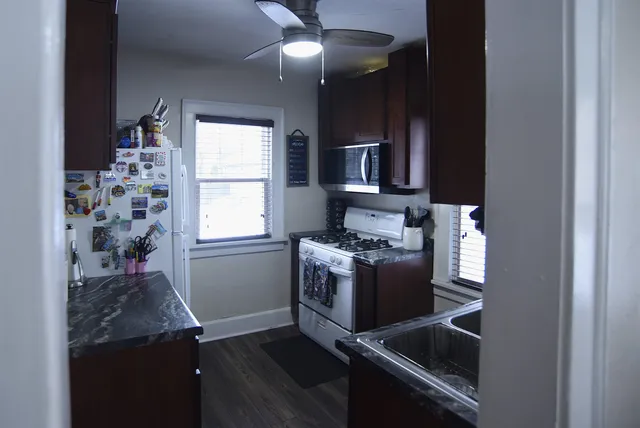 a kitchen with granite countertop a stove and a refrigerator