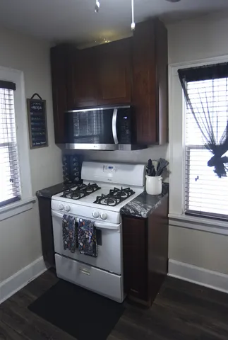 a stove top oven sitting inside of a kitchen
