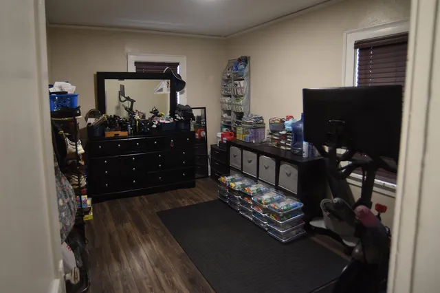 a bed room with a bed tv and a mirror