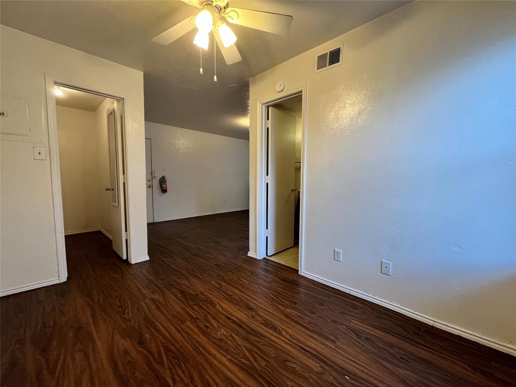 2526 West Prairie Street, Unit 203 Denton, TX 76201 - Photo 5 of 7 an empty room with wooden floor and closet