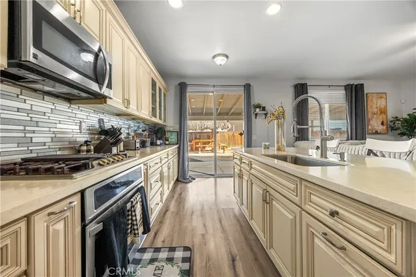 a kitchen with stainless steel appliances granite countertop a sink and cabinets