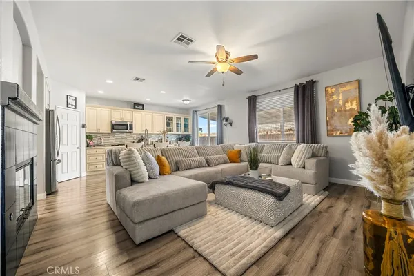a living room with furniture white walls and a fireplace