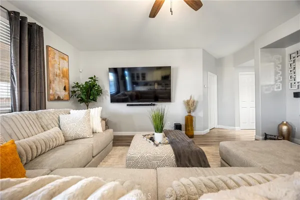 a living room with couches and a flat screen tv