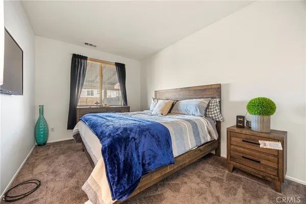 a bedroom with a bed table and window