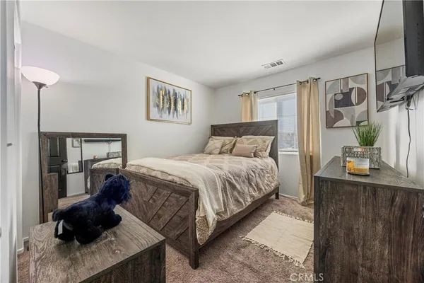 a bedroom with a bed window and wall painting