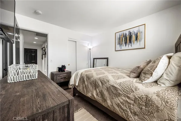 a bedroom with a bed and glass wall