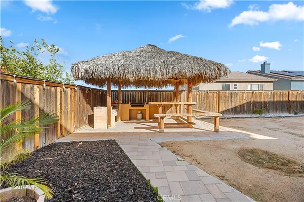 a view of a patio with a table and chairs