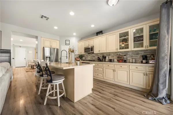 a kitchen with a table chairs refrigerator and cabinets