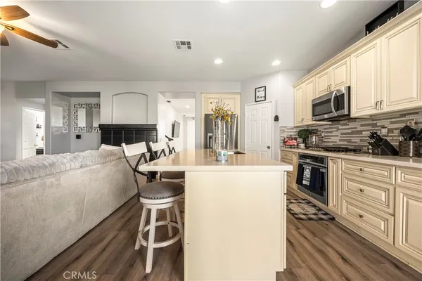 a kitchen with stainless steel appliances a stove a sink and a refrigerator