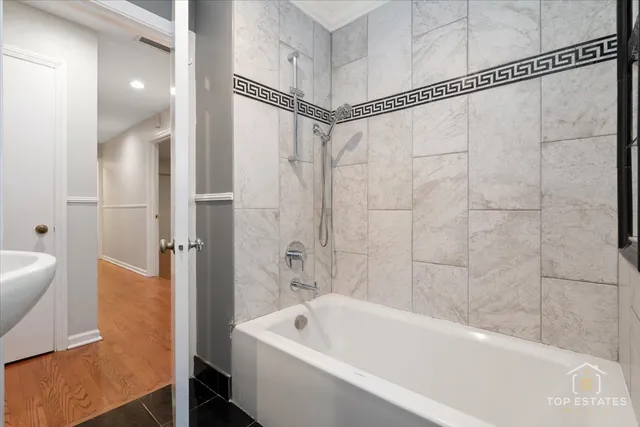 a bathroom with a bathtub and a shower