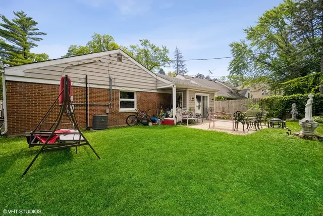 a view of a backyard with table and chairs and potted plants