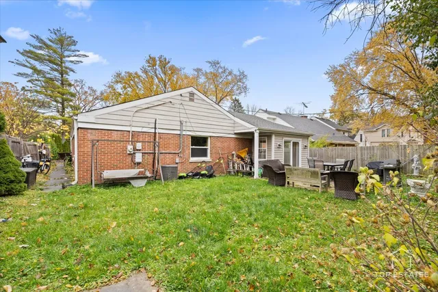 a view of a house with a yard patio and sitting area