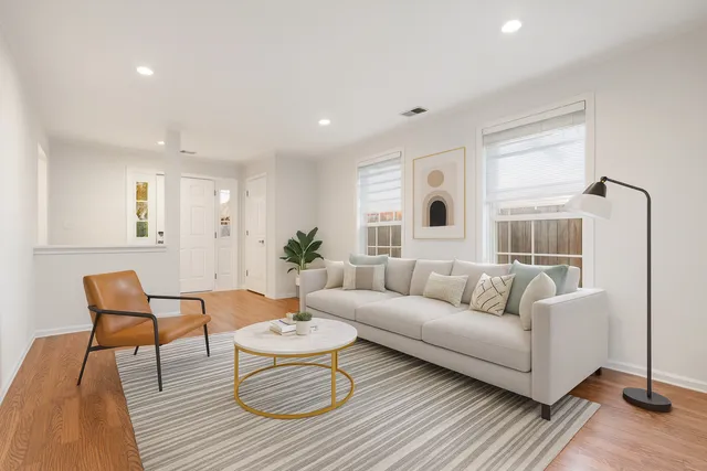 a living room with furniture and wooden floor