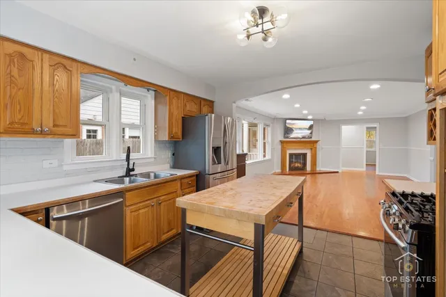 a kitchen with a sink appliances and a counter top space