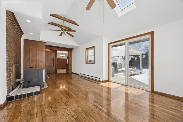 a view of a livingroom with wooden floor and furniture