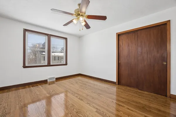 wooden floor in an empty room with a window